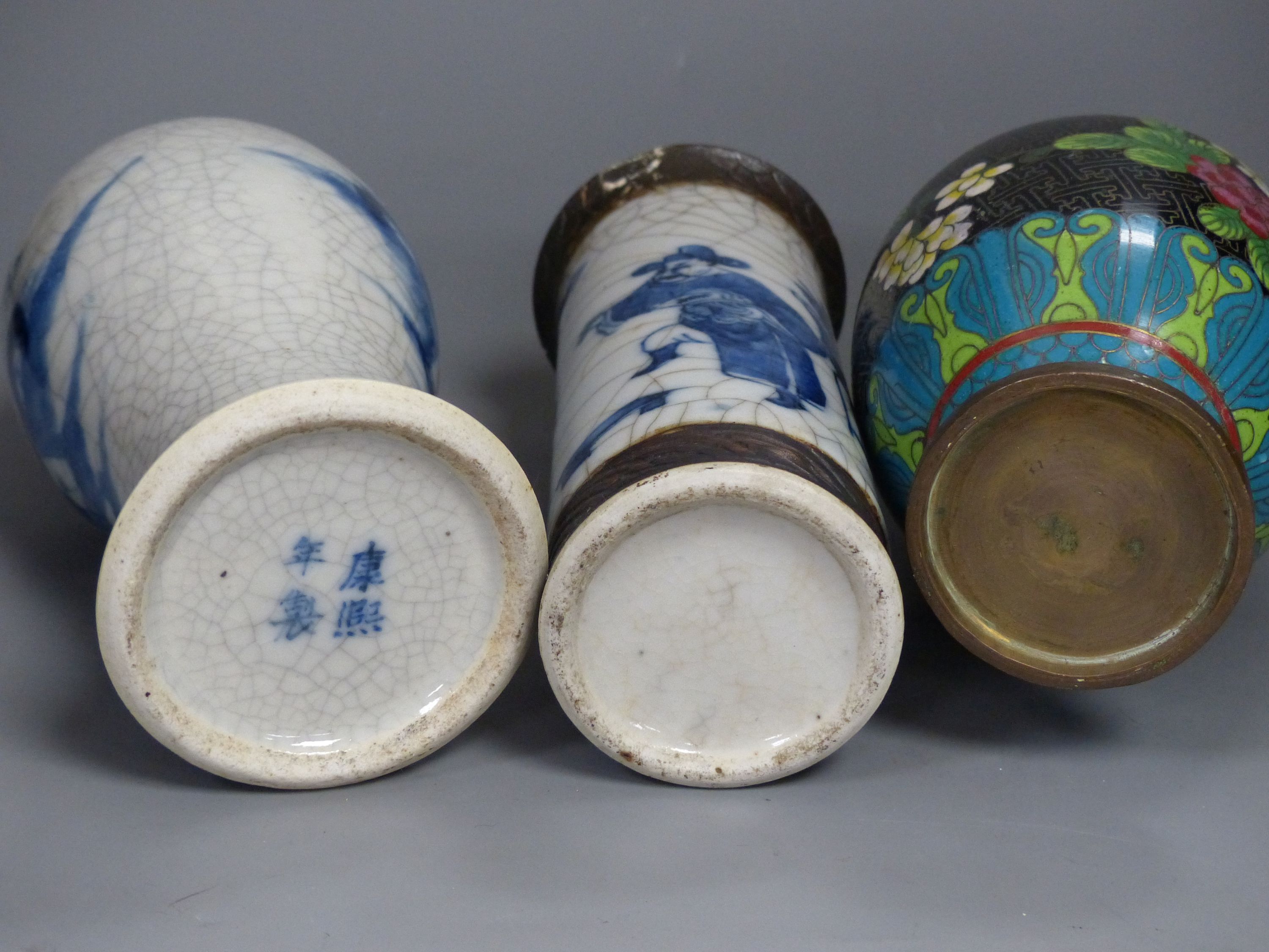 Three Chinese blue and white vases, a cloisonne enamel vase, another vase and a soapstone figure